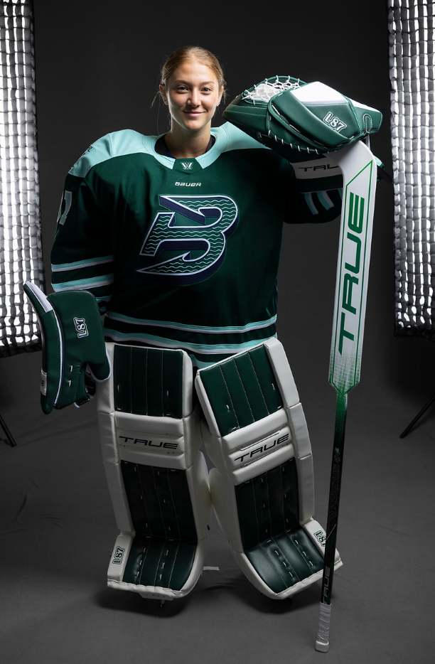 Frankel models the new Boston Fleet home jersey in her green and white True goalie gear.