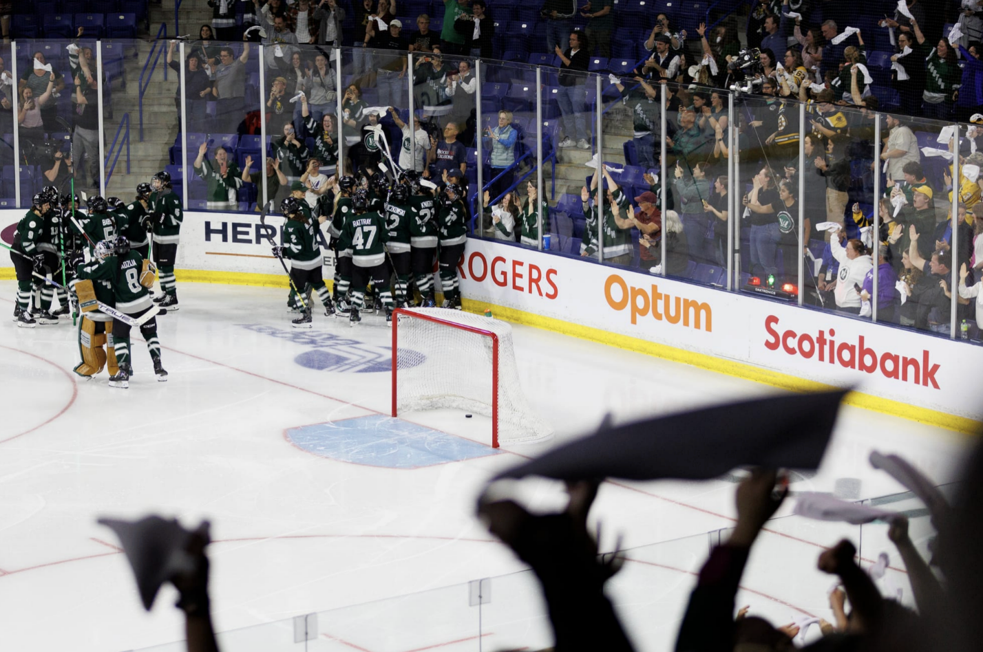 Boston celebrates with multiple big hugs in the corner, while fans cheer in the background.