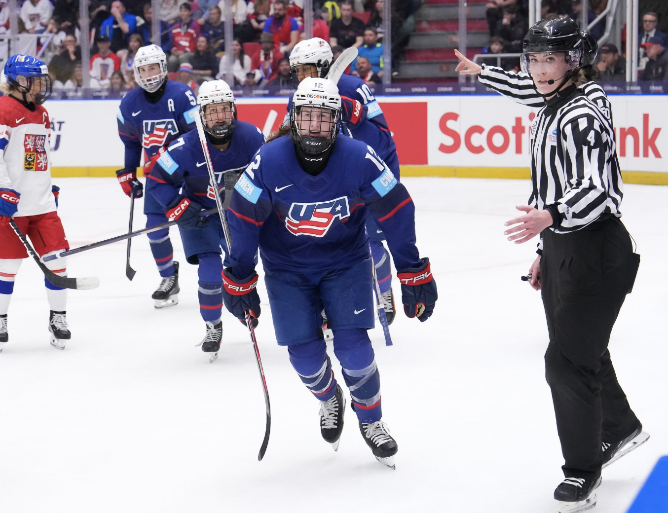 Pannek leads the line of skaters heading to the bench for handshakes. They are all wearing blue uniforms.