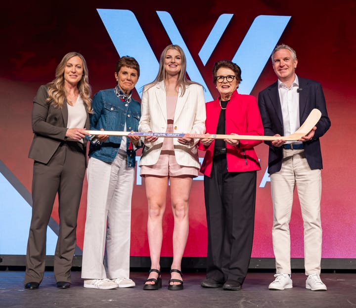 Danielle Serdachny stands on the PWHL draft stage.