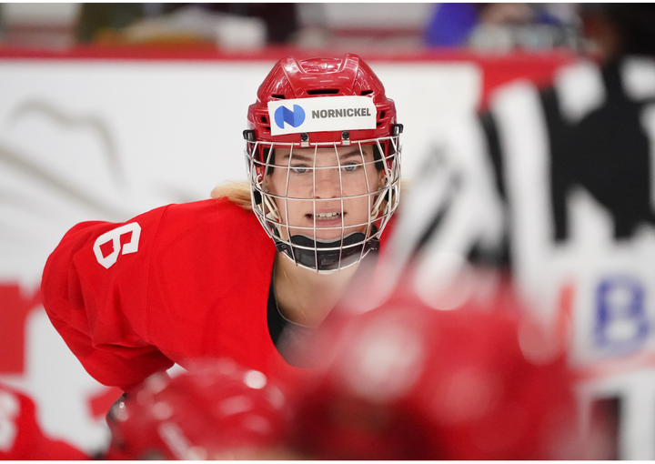Ilona Markova in a red Russian Olympic Committee jersey lines up for a face off.