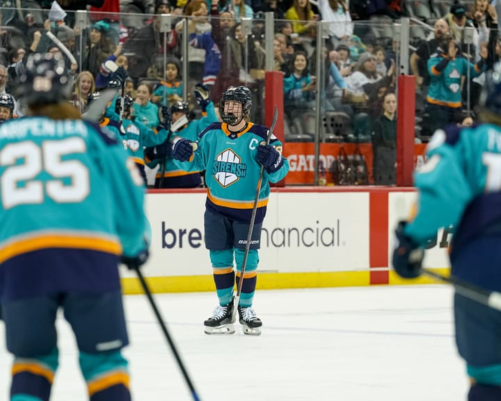 Zandee-Hart yells and pumps her fists in celebration. She is wearing a teal home uniform.
