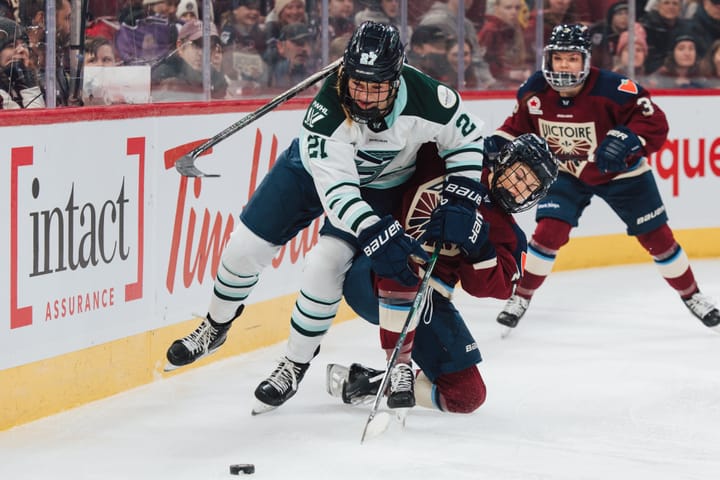 A Montréal player (right in maroon) falls with her stick wrapped around Maloney (left in white), who is leaning into her.