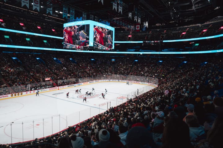 A wide angle shot of the crowd and ice at the Bell Centre as Boston and Montréal prepare for a center ice faceoff.