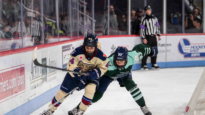 Boston Fleet forward Theresa Schafzahl (right) gets her stick caught trying to retrieve the puck from Montréal Victoire defender Amanda Boulier.