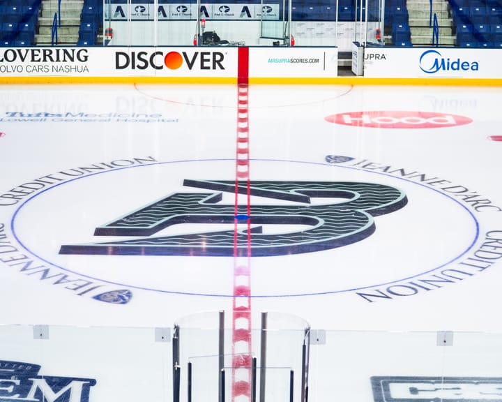 The Fleet's logo, a green anchor shaped like a B, splits the Tsongas Center center ice line. 